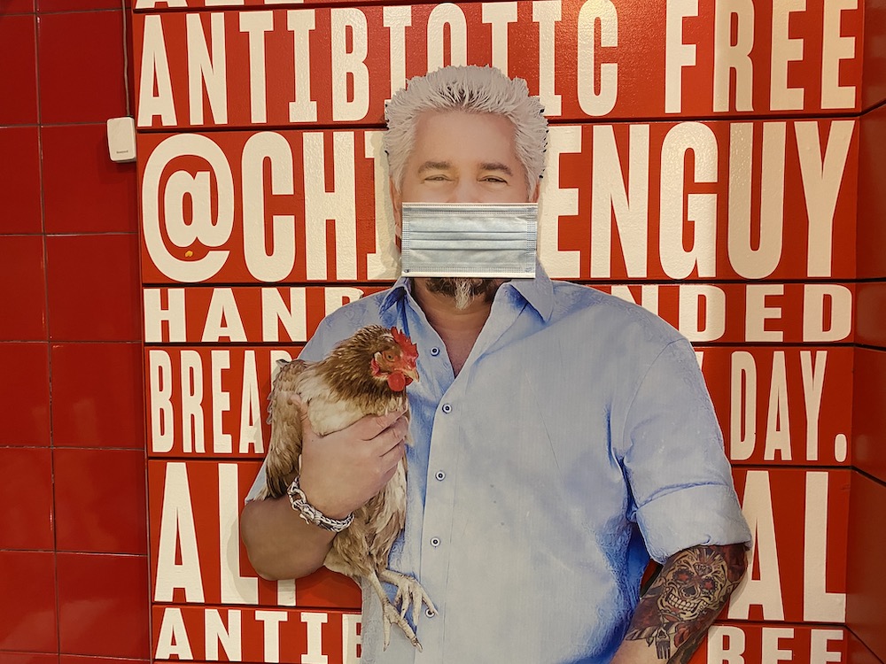 Guy Fieri with a mask and chicken